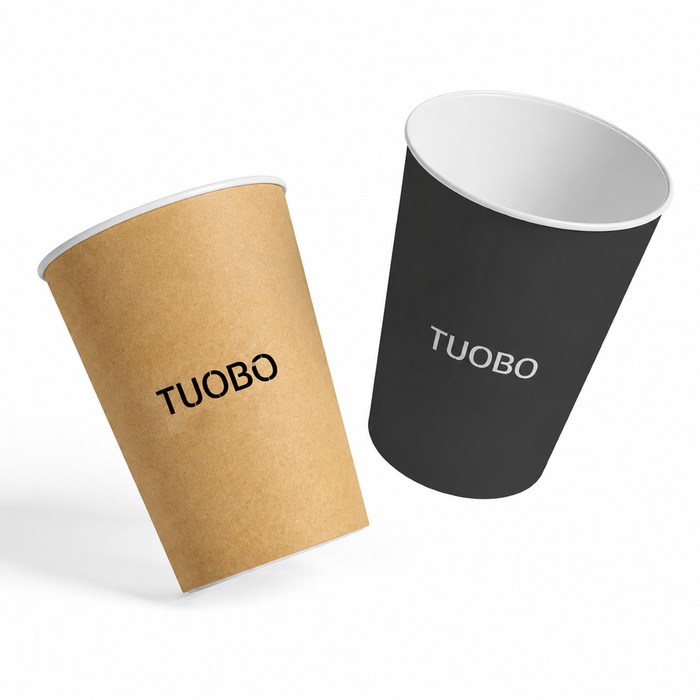 A brown kraft paper cup and a black paper cup featuring custom printed branding presented on a plain white background.