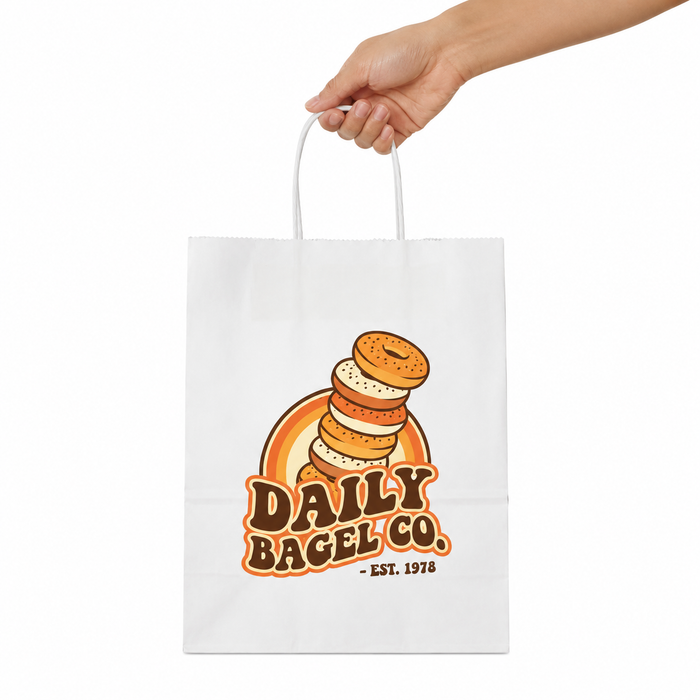  Hand holding custom printed twisted handle paper bags, eco friendly recycled paper bags, wholesale paper shopping bags ideal for bread packaging and pastry shop retail packag
