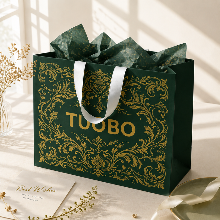Soft window natural light lifestyle photo luxury green shopping bag filled with matching printed tissue paper, vintage gold foil TUOBO print, minimalist home decor background for boutique gift packaging